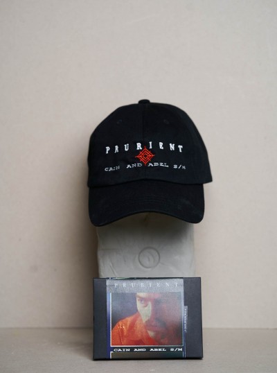 Prurient / Cain And Abel cassette + casquette